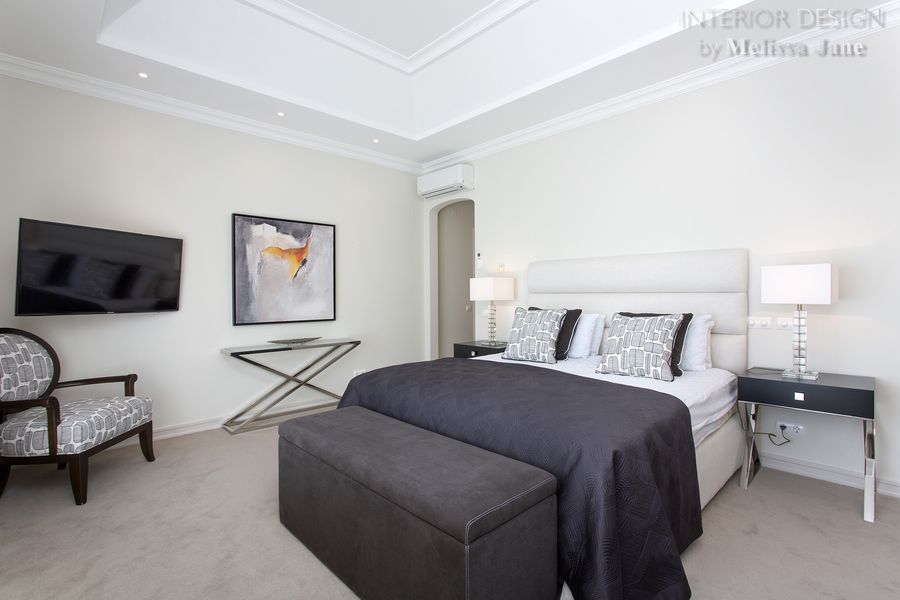 Bedroom with white tufted bed, dark bench and wall television — Quinta Verde, Algarve