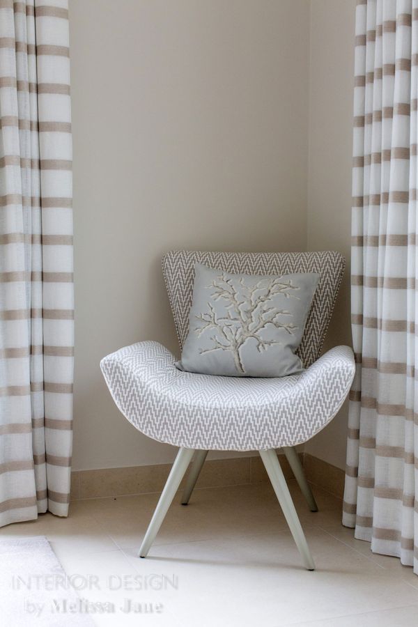 White armchair beside patterned drapery in a bedroom corner — Quinta Verde, Algarve