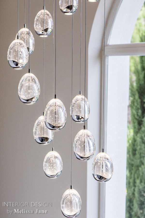 Teardrop glass pendant lamps before a tall arched window — Quinta Verde, Algarve