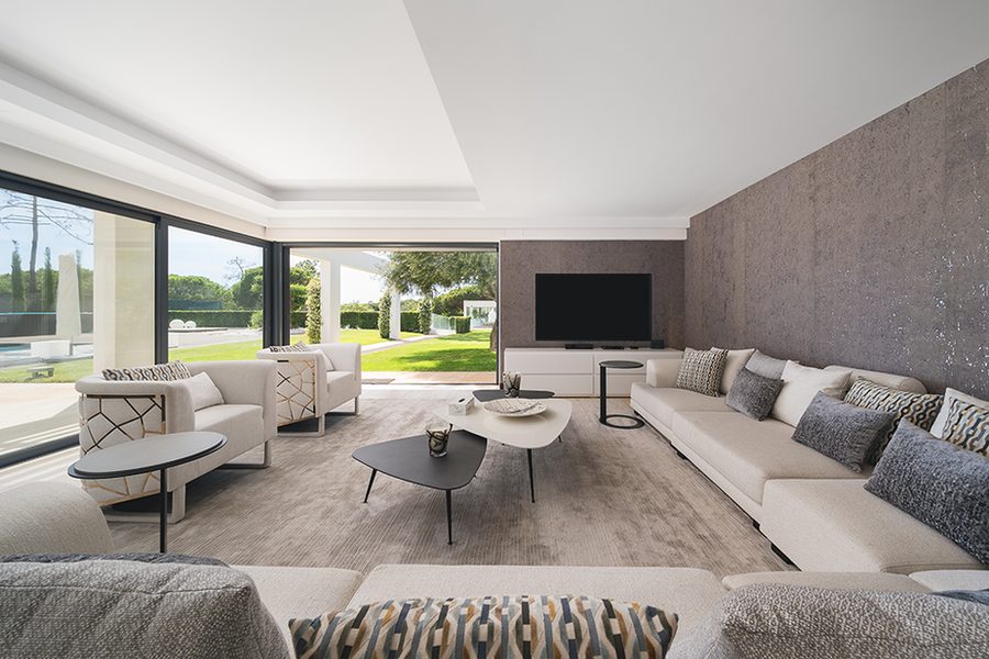 Light living room with pale sofa and garden views