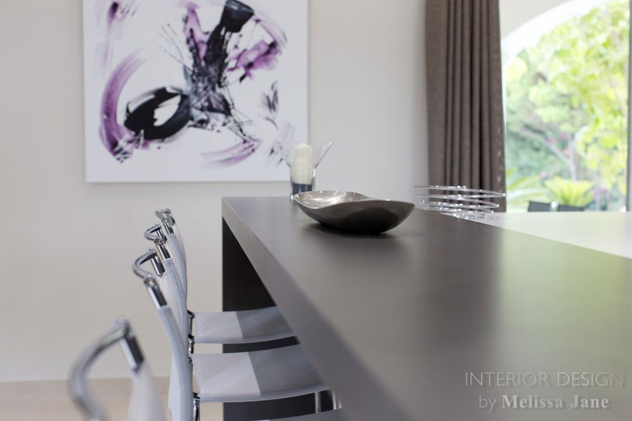 Dining table with centrepiece bowl beneath abstract wall art — Quinta Verde, Algarve