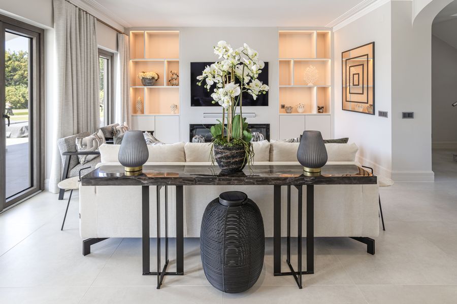 Living room with illuminated shelving and white orchids — Quinta da Luz, Quinta do Lago