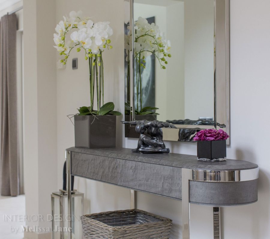 Entryway console table with mirror, orchids and sculptures — Quinta Verde, Algarve