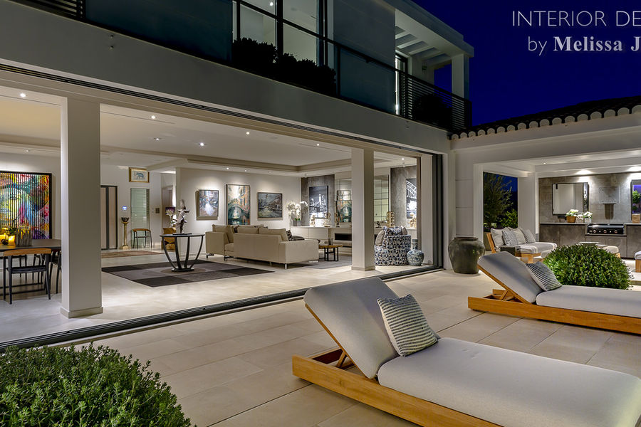 Illuminated villa terrace beside the swimming pool at dusk